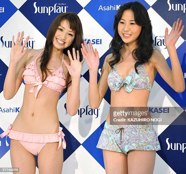 Campaign girls for Japanese swimwear maker Asahi Kasei, Yuki Shikanuma of Japan and Zhang Ziwei of China model the company's latest swimwear during a...