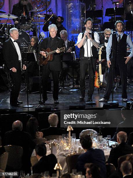 Inductees Allan Clarke and Graham Nash of the Hollies perform with Adam Levine and Jesse Carmichael of Maroon 5 onstage at the 25th Annual Rock And...