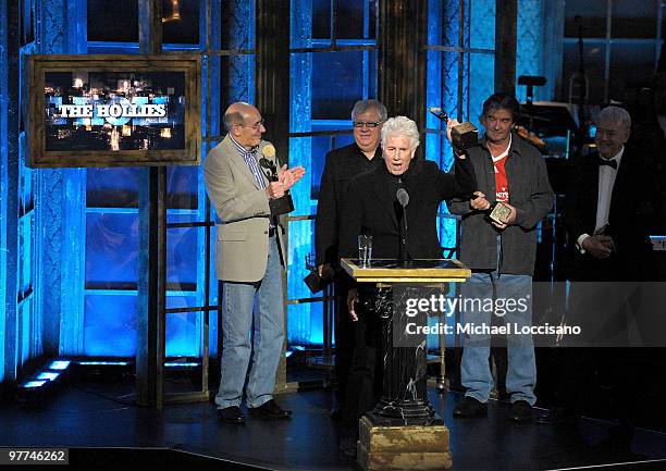 Inductees Bernie Calvert, Eric Haydock, Graham Nash, Terry Sylvester and Allan Clarke of the Hollies speak onstage at the 25th Annual Rock And Roll...