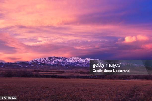 colorful sky over snowy mountains, bozeman, gallatin, montana, usa - bozeman stock pictures, royalty-free photos & images