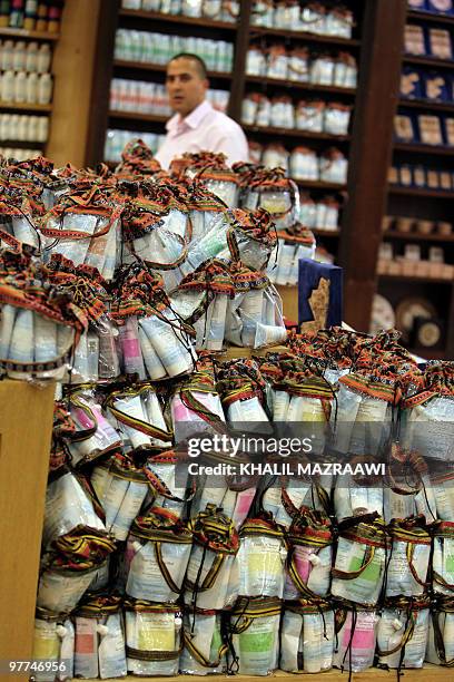 Jordanian man stands behind packages of Dead Sea sking care and beauty products at a shop in the Jordanian capital Amman on March 15, 2010. Jordan...