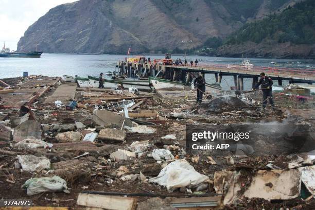 People work in destroyed houses in Juan Fernandez Islands, in the South Pacific Ocean, 667km off the coast of Chile on March 3, 2010.The official...