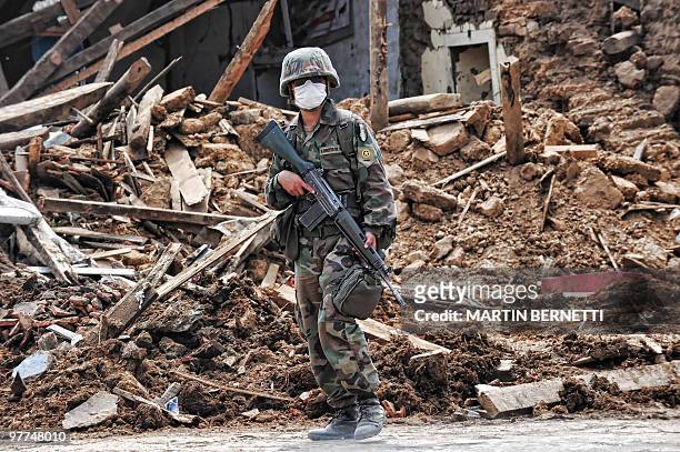 Chilean soldier patrols a street in Constitucion, 300km south of Santiago on March 3, 2010.The official death toll from Saturday's 8.8-magnitude...