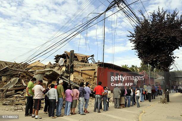 People queue up to register and get general assistance in Constitucion, 300km south of Santiagoon March 3, 2010.The official death toll from...