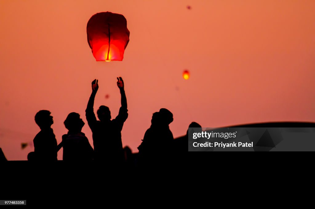 People launching chinese lanterns, Gujarat, India