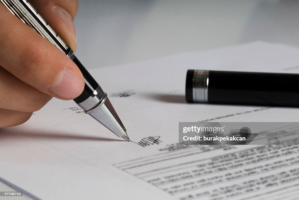 Businesswoman signing documents, Close-up of hands