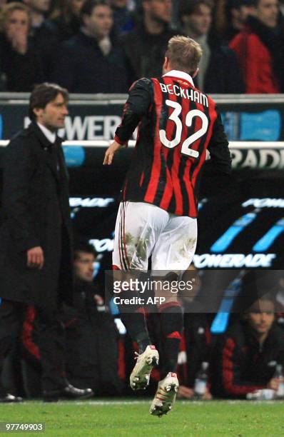 Milan's English midfielder David Beckham limps off the field after injuring his ankle during the Italian Serie A football match AC Milan against...