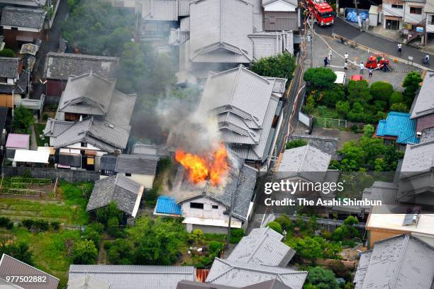 In this aerial image, fire breaks out at a house after the magnitude 6.1 earthquake on June 18, 2018 in Takatsuki, Osaka, Japan. A powerful...