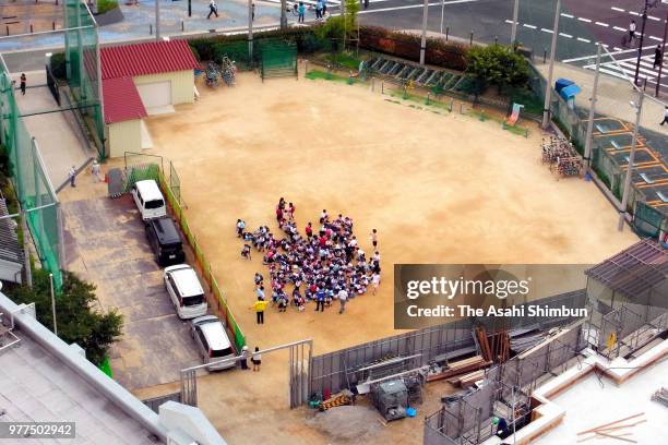 In this aerial image, school children evacuate at their school ground after the Magnitude 6.1 earthquake on June 18, 2018 in Osaka, Japan. A powerful...