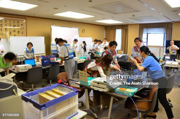 Officers work at Osaka City Hall Disaster Management Division after the magnitude 6.1 strong earthquake suspending the service on June 18, 2018 in...