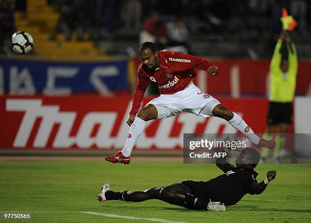 Brazil's Internacional Alecsandro vies for the ball with Ecuador's Deportivo Quito Isaac Mina during their Copa Libertadores 2010 football match at...