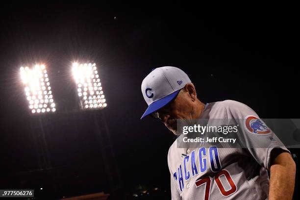 Joe Maddon of the Chicago Cubs walks back to the dugout during the eighth inning against the St. Louis Cardinals at Busch Stadium on June 17, 2018 in...