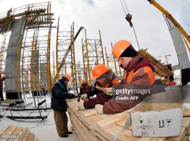 Workers nail boards on March 16, 2010 at the construction site of a football stadium for the Euro 2012 in the western Ukrainian city of Lviv. Poland...