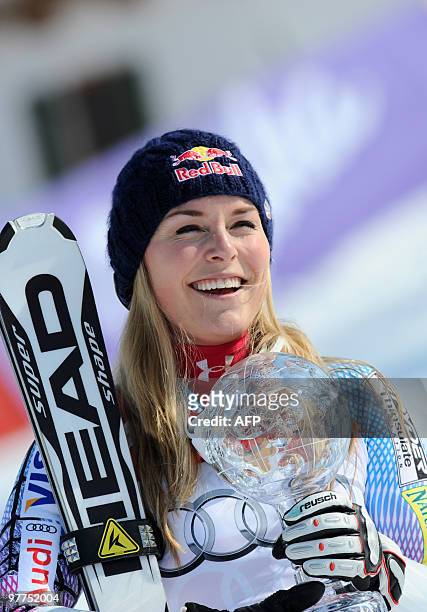 Overall winner and race winner US Lindsey Vonn poses with the globe in the finish area after the women's Alpine skiing World Cup Super G Slalom...