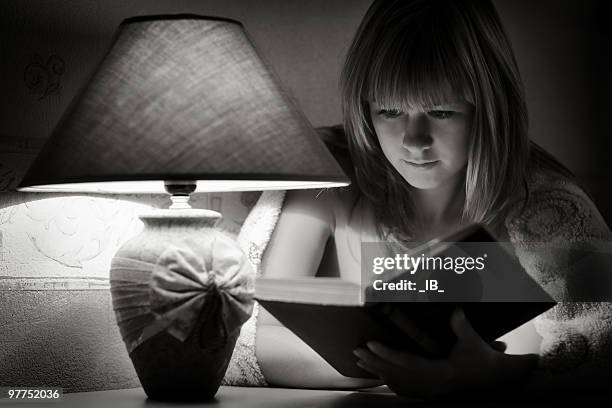 young girl reads the book. night and lamp light - ronnie corbett signs copies of his book and its goodnight from him at stockfoto's en -beelden