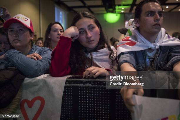 Supporters for Gustavo Petro, presidential candidate for the Progressivists Movement Party, not pictured, react during an election night rally in...