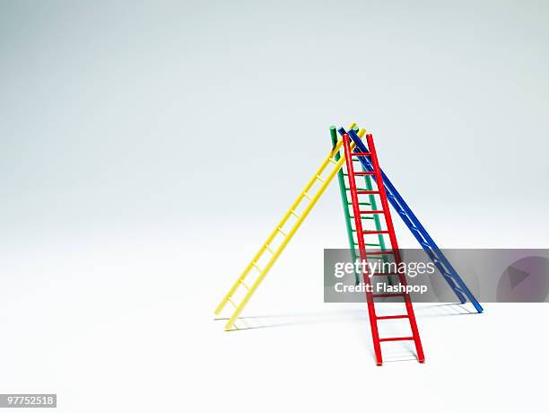 four ladders supporting each other - ladder stock pictures, royalty-free photos & images