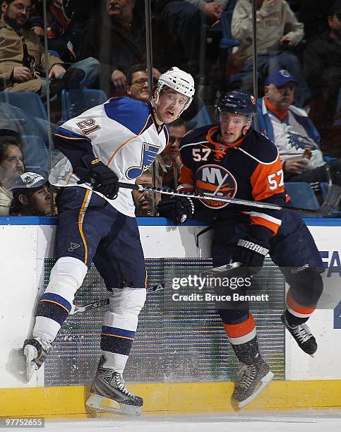 Patrik Berglund of the St. Louis Blues collides with Blake Comeau of the New York Islanders at the Nassau Coliseum on March 11, 2010 in Uniondale,...