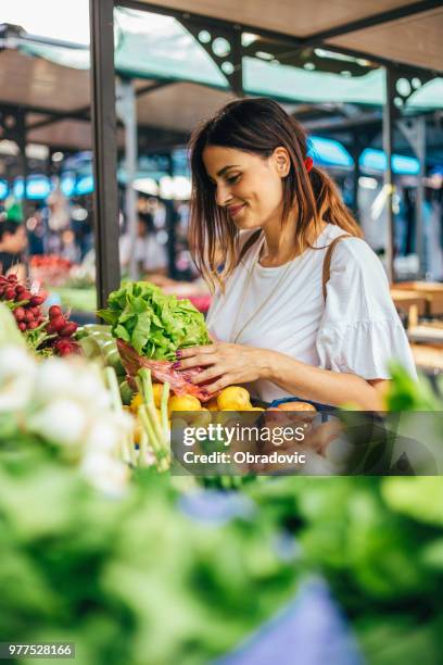 satisfied buying, puts vegetables in the bag - serbia supermarket stock pictures, royalty-free photos & images