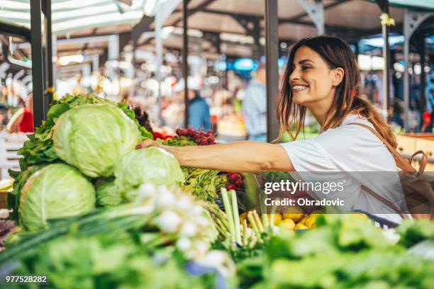 smiling girl decided to cook a delicious and healthy meal - supermarket exterior stock pictures, royalty-free photos & images