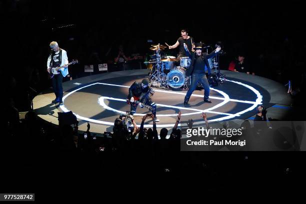 Adam Clayton, The Edge, Larry Mullen, Jr. And Bono of U2 perform during the eXPERIENCE + iNNOCENCE TOUR at the Capital One Arena on June 17, 2018 in...