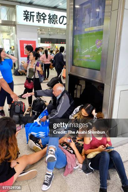 Passengers of Shinkansen are seen at Shin Osaka Station after the magnitude 6.1 strong earthquake suspending the service on June 18, 2018 in Osaka,...