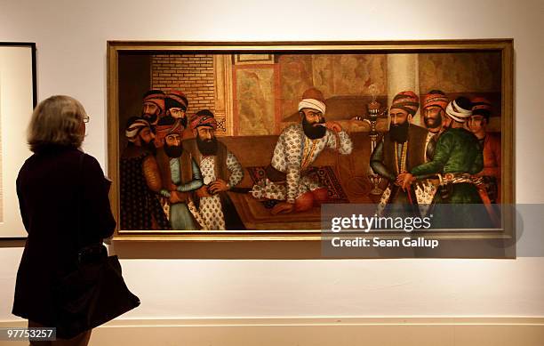 Visitor looks at an 18th century painting of Karim Khan Zand at the 'Treasures of the Aga Khan Museum - Masterpieces of Islamic Art' exhibition at...