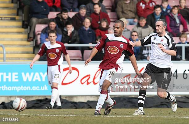 Alex Dyer of Northampton Town plays the ball watched by Gary Dempsey of Darlington during the Coca Cola League Two Match between Northampton Town and...