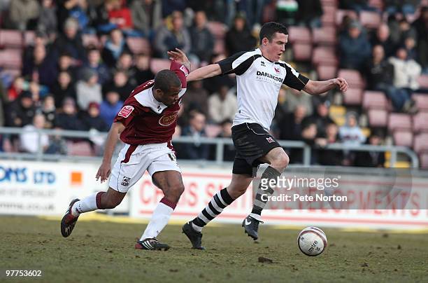 Tadgh Purcell of Darlington moves away from Alex Dyer of Northampton Town during the Coca Cola League Two Match between Northampton Town and...