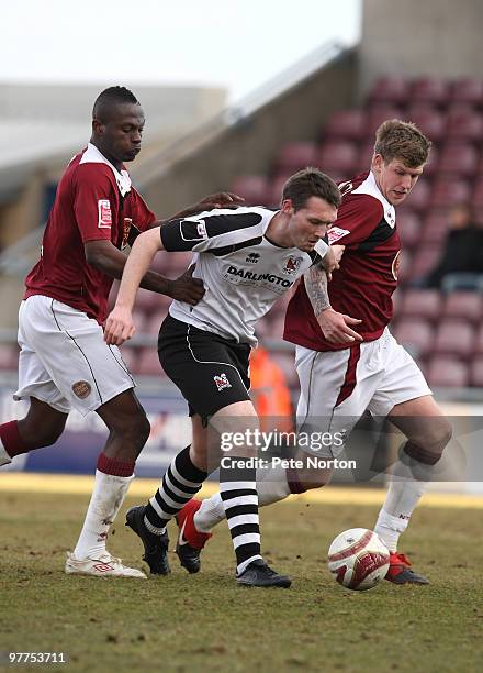 Patrick Deane of Darlington moves between Abdul Osman and Dean Beckwith of Northampton Town during the Coca Cola League Two Match between Northampton...