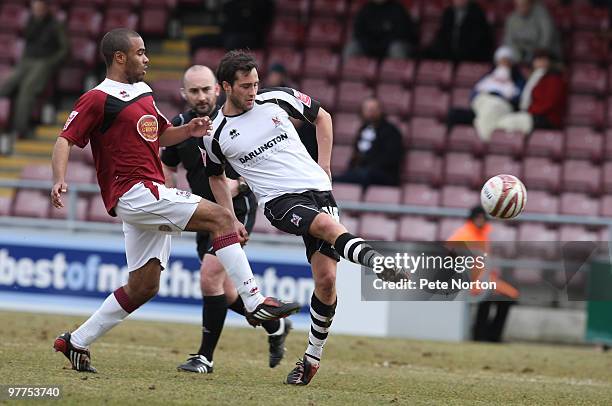 Gary Smith of Darlington plays the ball under pressure from Alex Dyer of Northampton Town during the Coca Cola League Two Match between Northampton...