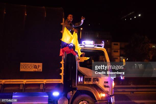 Man shouts as he rides a truck during an election rally for Ivan Duque, Colombia's president-elect, not pictured, in Bogota, Colombia, on Sunday,...
