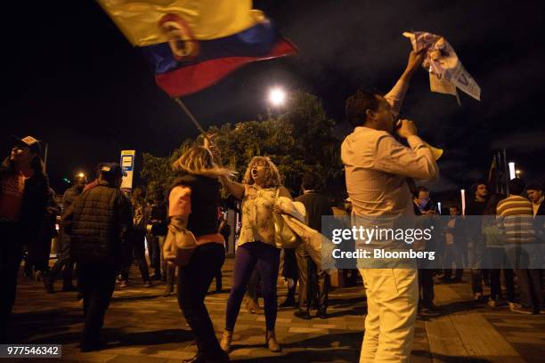 Supporters celebrate on the streets during an election rally for Ivan Duque, Colombia's president-elect, not pictured, in Bogota, Colombia, on...