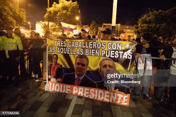 People gather on the streets during an election rally for Ivan Duque, Colombia's president-elect, not pictured, at the party's headquarters in...