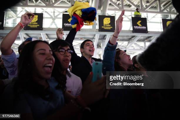 Supporters celebrate during an election rally for Ivan Duque, Colombia's president-elect, not pictured, at the party's headquarters in Bogota,...