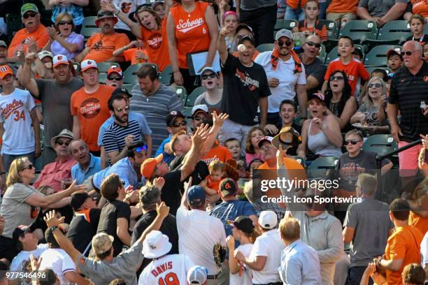 The crowd looks to catch a home run ball during the interleague game between the Miami Marlins and the Baltimore Orioles on June 16 at Orioles Park...