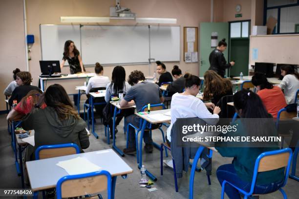 High school students wait to start a 4 hours philosophy dissertation, that kicks off the French general baccalaureat exam for getting into...