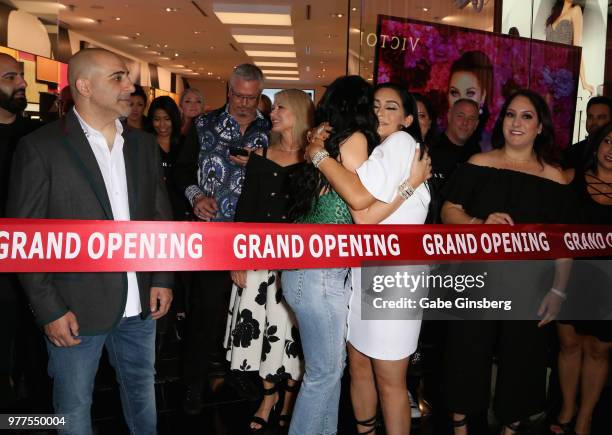 Morphe co-owner Chris Tawil watches as YouTube personality Jaclyn Hill hugs Morphe co-owner Linda Tawil before a ribbon cutting at a Morphe store...