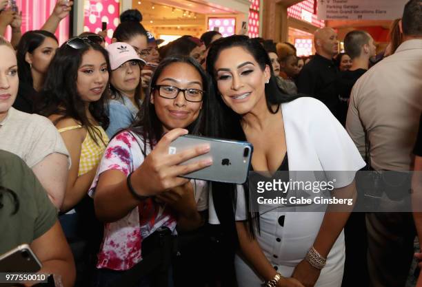 Customer takes a photo with Morphe owner Linda Tawil during a Morphe store opening at the Miracle Mile Shops at Planet Hollywood Resort & Casino on...