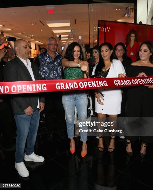 Morphe co-owner Chris Tawil, YouTube personality Jaclyn Hill and Morphe co-owner Linda Tawil prepare to cut a ribbon cutting during Morphe store...