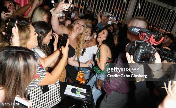 YouTube personality Jaclyn Hill takes selfies with fans during Morphe store opening at the Miracle Mile Shops at Planet Hollywood Resort & Casino on...