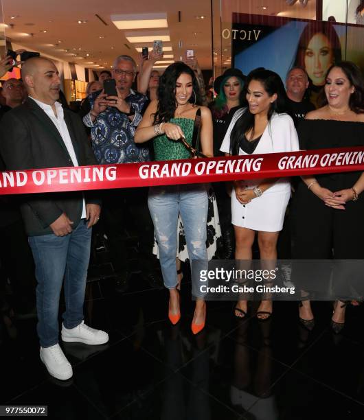 Morphe co-owner Chris Tawil, YouTube personality Jaclyn Hill and Morphe co-owner Linda Tawil prepare to cut a ribbon cutting during Morphe store...