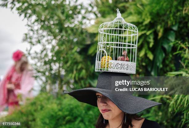 Woman wearing a hat attends the 169thPrix de Diane horse racing on June 17, 2018 in Chantilly, northern Paris.