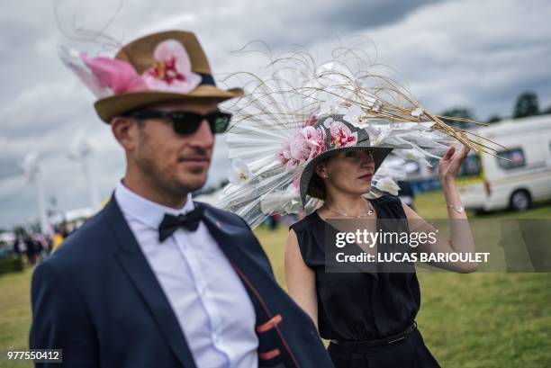 People wearing hats attend the 169thPrix de Diane horse racing on June 17, 2018 in Chantilly, northern Paris.