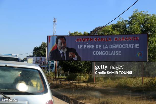 Poster is seen paying tribute to DRCongo president Joseph Kabila in Lubumbashi the capital of the mining region of Katanga on June 14, 2018. - Both...