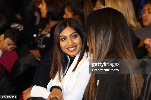 Women watch as Indian models showcase elegant and ornate Kanchipuram sarees during a South Asian bridal fashion show held in Scarborough, Ontario,...