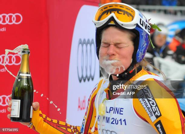 Canada's Emily Brydon celebrates with champagne her retirement from professional skiing in the finish area after the women's Alpine skiing World Cup...