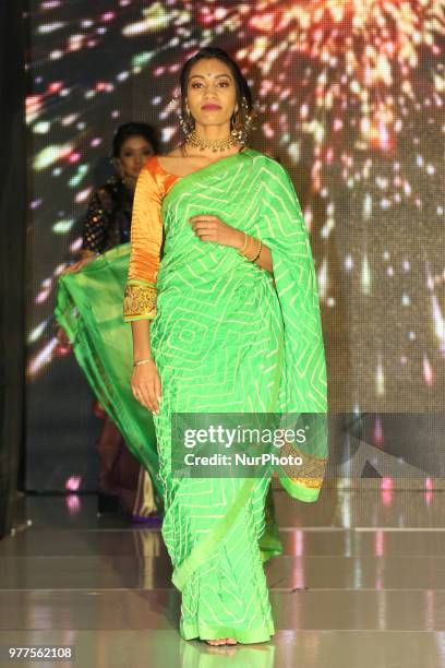 Indian model wearing an elegant designer saree during a South Indian bridal fashion show held in Scarborough, Ontario, Canada.