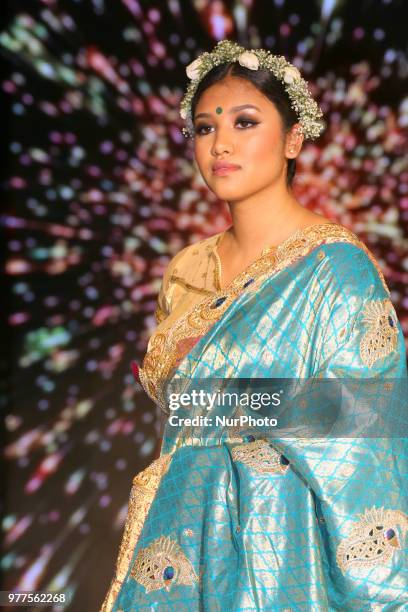 Indian model wearing an elegant and ornate Kanchipuram saree inlayed with peacock feathers during a South Asian bridal fashion show held in...