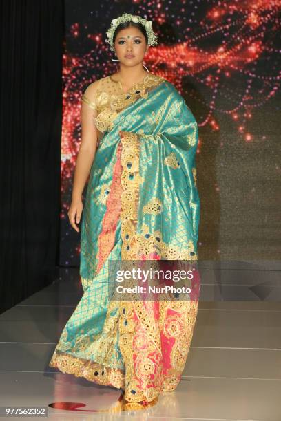 Indian model wearing an elegant and ornate Kanchipuram saree inlayed with peacock feathers during a South Asian bridal fashion show held in...